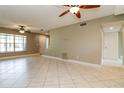 Spacious living room featuring neutral walls, tile flooring and ceiling fan at 16012 Ballica Dr, Tampa, FL 33618