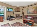 Cozy living room featuring a brick fireplace and built-in display shelves at 17108 Longacres Ln, Odessa, FL 33556