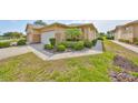 Well-maintained single-story home featuring lush landscaping and a two-car garage at 2112 Acadia Greens Dr # 62, Sun City Center, FL 33573