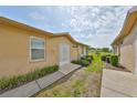 Back of house with well-manicured garden, new AC, and great side yard at 2112 Acadia Greens Dr # 62, Sun City Center, FL 33573