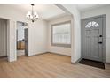 Bright dining room featuring modern light fixture, wood flooring, and gray accents at 2125 Acorn S Pl, St Petersburg, FL 33712
