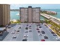 Stunning aerial view of condo complex, showcasing ample parking, waterfront views, and nearby bridge access at 5220 Brittany S Dr # 210, St Petersburg, FL 33715