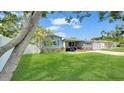 Charming single-story home with manicured lawn, stone accents and cozy covered porch at 5248 Coral N Way, St Petersburg, FL 33714