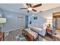 Comfortable living room with ceiling fan, neutral sofa, and view into dining area at 5248 Coral N Way, St Petersburg, FL 33714