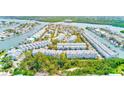 Aerial view of a coastal community with waterfront homes, docks, and lush greenery at 615 Garland Cir, Indian Rocks Beach, FL 33785