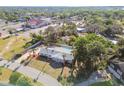 Expansive aerial view of a single-story home with a pool and palm trees at 6235 Viola Ln, New Port Richey, FL 34653