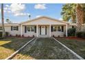 Charming one-story home with a covered front porch and beautiful landscaping at 6235 Viola Ln, New Port Richey, FL 34653