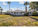 Charming one-story home with a well-maintained lawn and beautiful palm trees at 6235 Viola Ln, New Port Richey, FL 34653
