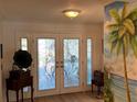 Inviting entryway with decorative front doors and unique wall decor at 6319 Cocoa Ln, Apollo Beach, FL 33572