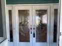 Elegant double front doors with decorative glass panels and modern hardware at 6319 Cocoa Ln, Apollo Beach, FL 33572
