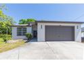 Well-kept single-story house with a two-car garage, manicured lawn, and tidy landscaping at 6426 31St S St, St Petersburg, FL 33712