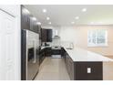Modern kitchen with stainless steel appliances, stylish backsplash, and sleek cabinetry at 6426 31St S St, St Petersburg, FL 33712