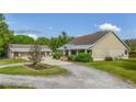 Landscaped front yard with a circular drive, and a detached garage at 6448 Country Club Rd, Wesley Chapel, FL 33544
