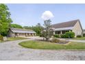 Beautiful home with a detached garage, circular drive, and mature landscaping at 6448 Country Club Rd, Wesley Chapel, FL 33544