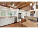 Open kitchen with hardwood floors, recessed lighting, stainless steel appliances, and wood-plank ceiling at 7500 141St St, Seminole, FL 33776