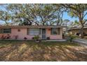 Charming home featuring mature landscaping, and a welcoming facade at 7819 Chasco St, Port Richey, FL 34668