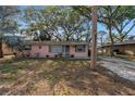 Charming home featuring mature landscaping, and a welcoming facade at 7819 Chasco St, Port Richey, FL 34668