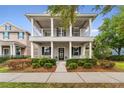 Charming two-story home featuring a covered porch with white columns and well-manicured landscaping at 16906 Dorman Rd, Lithia, FL 33547