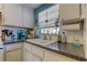 Bright kitchen corner with sink, window and nautical decor details at 1847 Shore Drive South # 308, South Pasadena, FL 33707