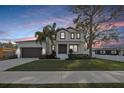 Charming two-story home featuring meticulously manicured landscaping with a gray two-car garage at 2904 W Averill Ave, Tampa, FL 33611