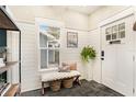Stylish entryway featuring shiplap walls, a window bench, and elegant decor at 2910 W Aquilla St, Tampa, FL 33629