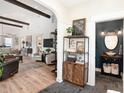 Open-concept living space with wood floors, high ceilings, and stylish furnishings at 2910 W Aquilla St, Tampa, FL 33629