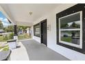 Inviting front porch with freshly painted floor, white railings, and a view of the neighborhood at 2920 E 20Th Ave, Tampa, FL 33605