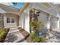 Close-up of stone accents, lighting, and paved walkway detailing exterior charm at 30174 Southernwood Ct, Wesley Chapel, FL 33543
