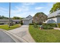 Charming single-story home with neutral siding, attached garage, manicured lawn, and American flag at 3254 Lori Ln, New Port Richey, FL 34655