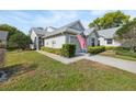 Well-maintained one-story home featuring a manicured lawn, attached garage, and an American flag at 3254 Lori Ln, New Port Richey, FL 34655