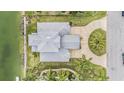 Birds eye view showcases a meticulously landscaped home with a lush green lawn and circular driveway at 3432 Bluefish Dr, Hernando Beach, FL 34607