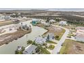 Aerial view of waterfront homes nestled along a scenic canal with access to the open water at 3432 Bluefish Dr, Hernando Beach, FL 34607