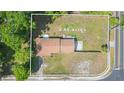 Aerial view of property showing 0.66 acres of land, house, and surrounding green foliage at 3502 Bloomingdale Ave, Valrico, FL 33596