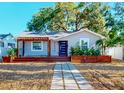 Charming single-story home with a modern black door and inviting wooden porch at 4530 5Th S Ave, St Petersburg, FL 33711