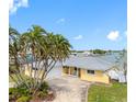 Beautiful home with lush palm trees and a spacious driveway providing ample parking at 512 173Rd E Ave, North Redington Beach, FL 33708