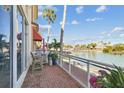 Relaxing outdoor patio area overlooking the waterfront with seating, plants, and brick flooring at 525 Mandalay Ave # 33, Clearwater Beach, FL 33767