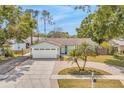 Aerial view of a landscaped home with a driveway and a well maintained yard at 5317 Black Pine Dr, Tampa, FL 33624