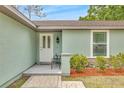 Inviting front entrance featuring a white door, stone accents, and fresh landscaping at 5317 Black Pine Dr, Tampa, FL 33624