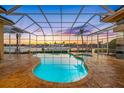 Inviting screened-in pool area with clear blue water, perfect for year-round enjoyment and showcasing waterfront views at 5812 Mariners Watch Dr, Tampa, FL 33615