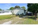 Charming single-story home with a spacious yard and a convenient driveway for easy parking and landscaped greenery at 6051 106Th N Ave, Pinellas Park, FL 33782