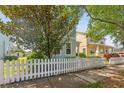 Charming two-story home featuring a picket fence, inviting entrance and lush landscaping at 6111 Hadley Commons Dr, Riverview, FL 33578