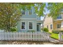 Charming two-story home featuring a picket fence, inviting entrance and lush landscaping at 6111 Hadley Commons Dr, Riverview, FL 33578