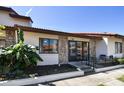 Inviting villa featuring a charming brick facade, tiled roof, and a cozy front patio area at 7360 Ulmerton Rd # 29B, Largo, FL 33771