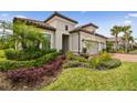 Well-manicured front yard featuring lush landscaping and healthy green grass at 8725 Sorano Villa Dr, Tampa, FL 33647