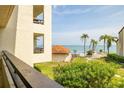 Balcony view of the pool, palm trees, and waterfront, creating a serene tropical oasis at 103 1St E St # 115, Tierra Verde, FL 33715