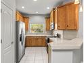 Traditional kitchen with stainless steel appliances, wooden cabinets, and a window above the sink at 10418 Tulip Field Way, Riverview, FL 33578