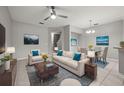Bright living and dining area featuring modern furnishings, neutral tones, and abundant natural light at 10418 Tulip Field Way, Riverview, FL 33578