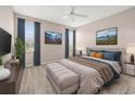 Serene main bedroom with a ceiling fan, plush carpet, and stylish decor at 10418 Tulip Field Way, Riverview, FL 33578
