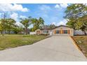 Charming single-story home featuring a well-manicured lawn and a long driveway at 11347 Amboy St, Spring Hill, FL 34609