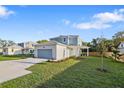 Beautiful two-story home featuring a well-kept lawn, paved driveway, and attached two car garage at 11598 Oak Ln, Largo, FL 33778